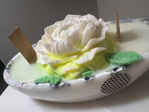 White rose candle in a tub with match sticks